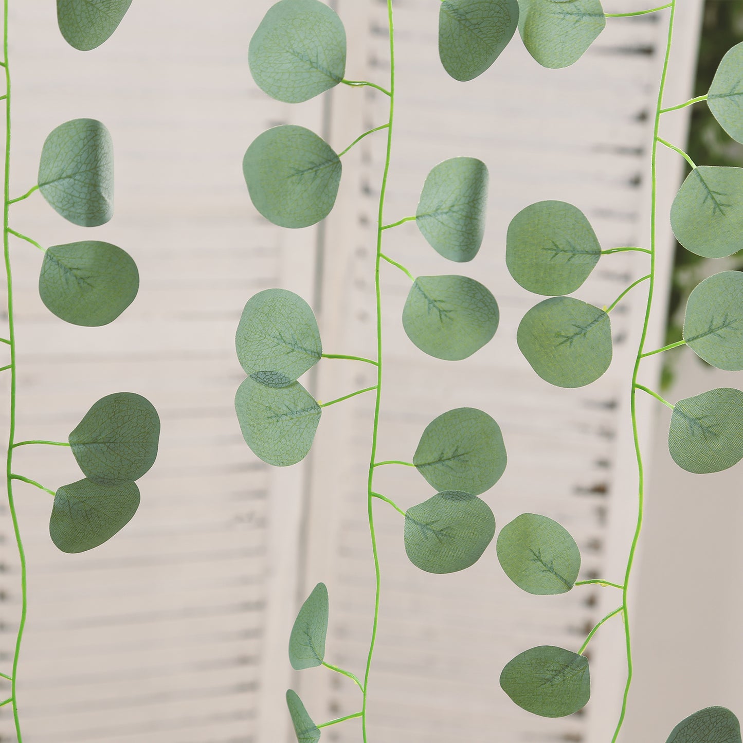 Green artificial eucalyptus leaves garland for wedding and party decor.