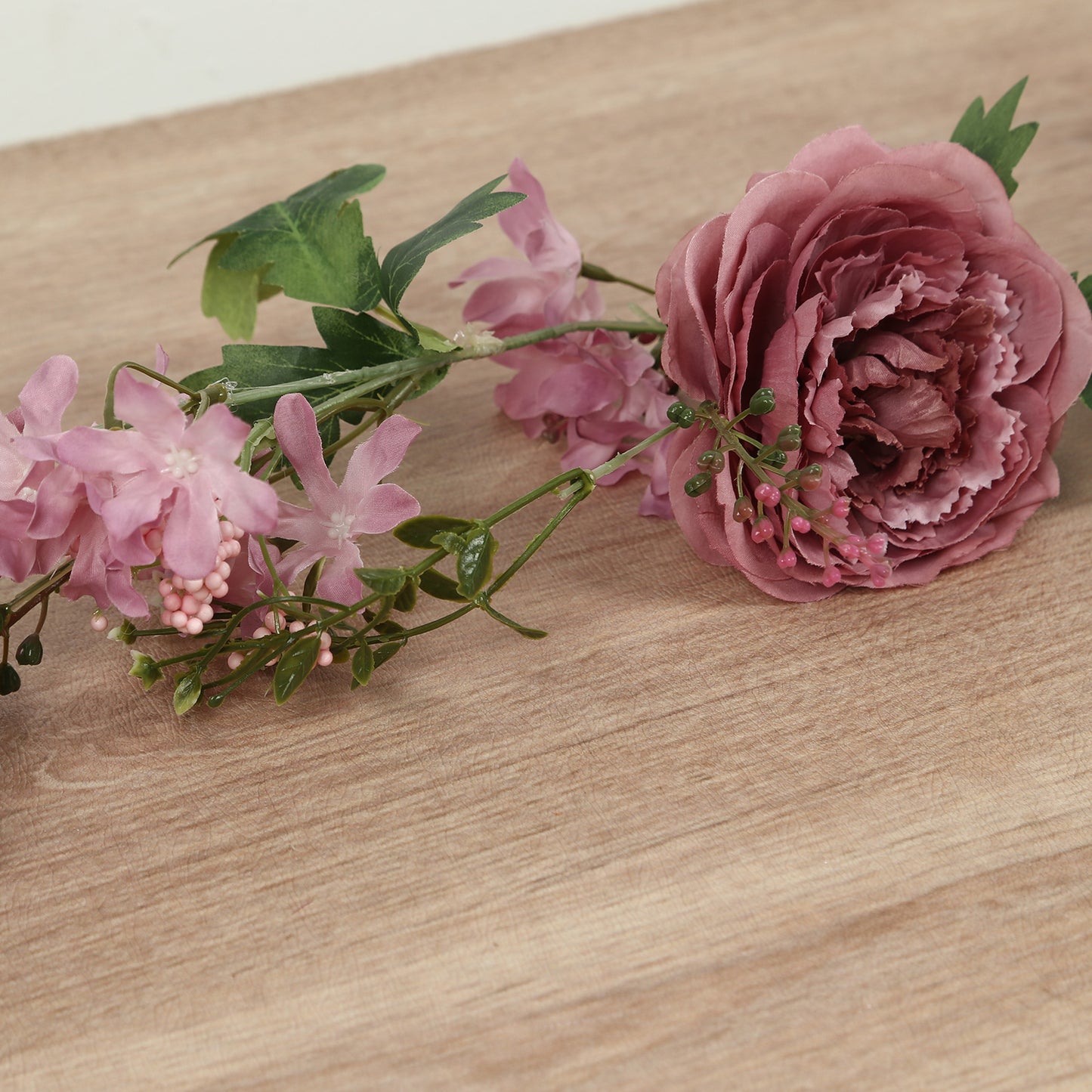 Dusty rose silk flower garland with greenery.