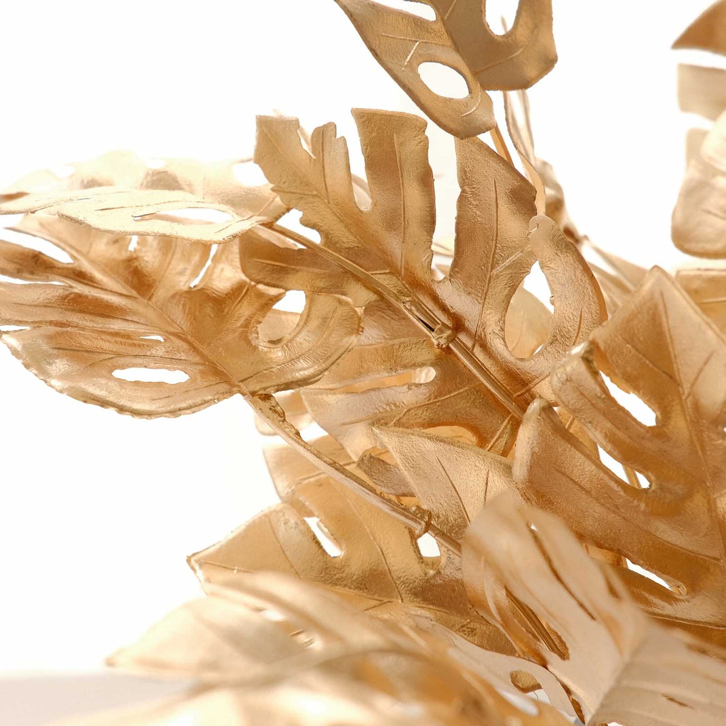 Metallic gold artificial monstera leaves bunches for home decor.