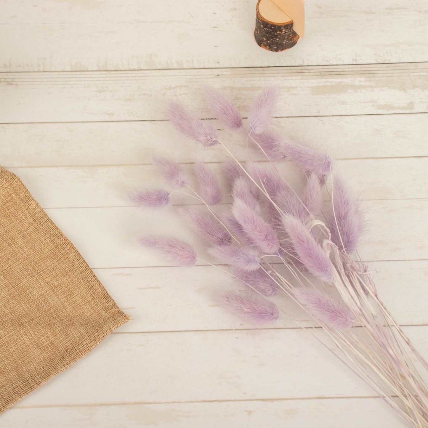 Lavender lilac dried pampas grass bouquet in a rustic setting.