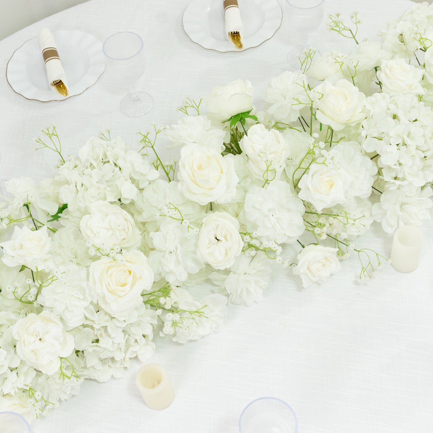White floral table runner featuring roses, hydrangeas, and baby's breath.