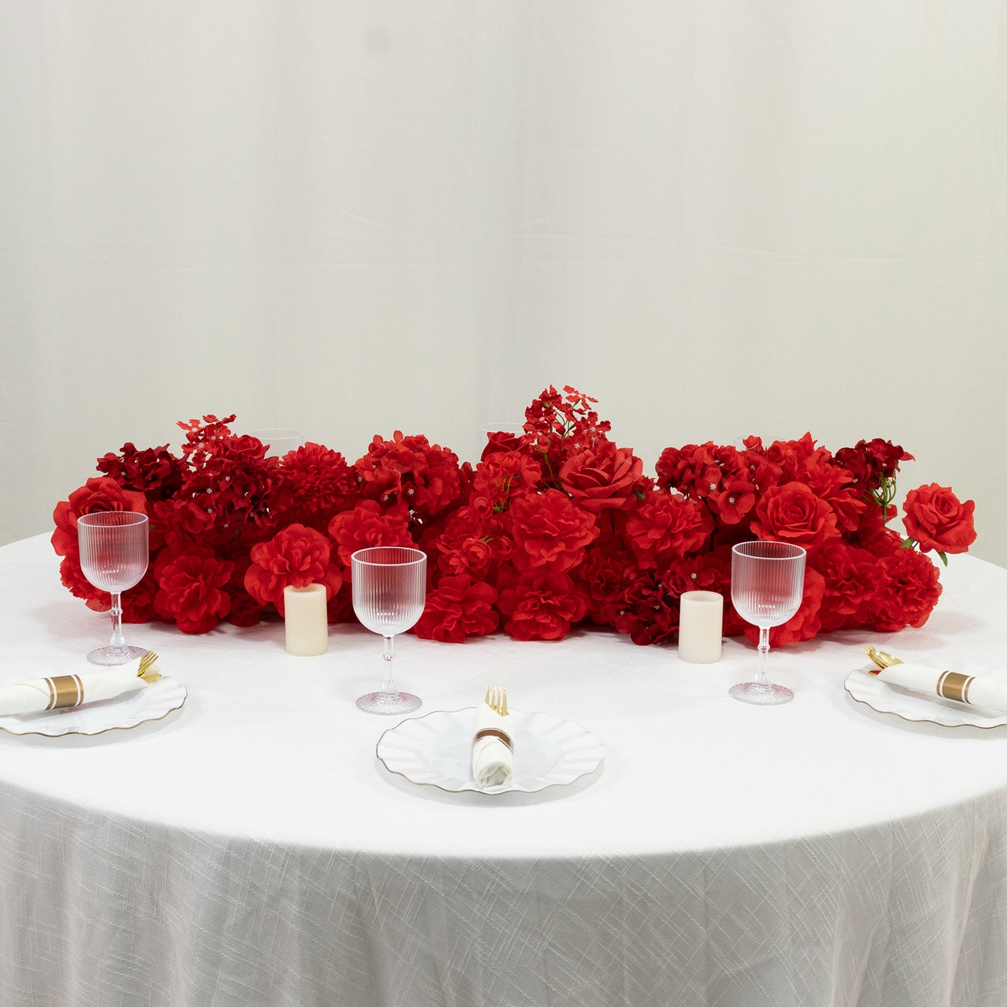 Mixed red silk flower table runner with roses, hydrangeas, and peonies.