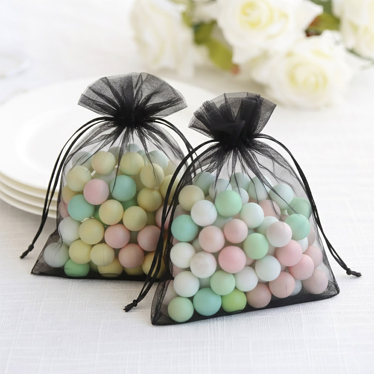 Black organza gift bags with drawstring, perfect for wedding favors.