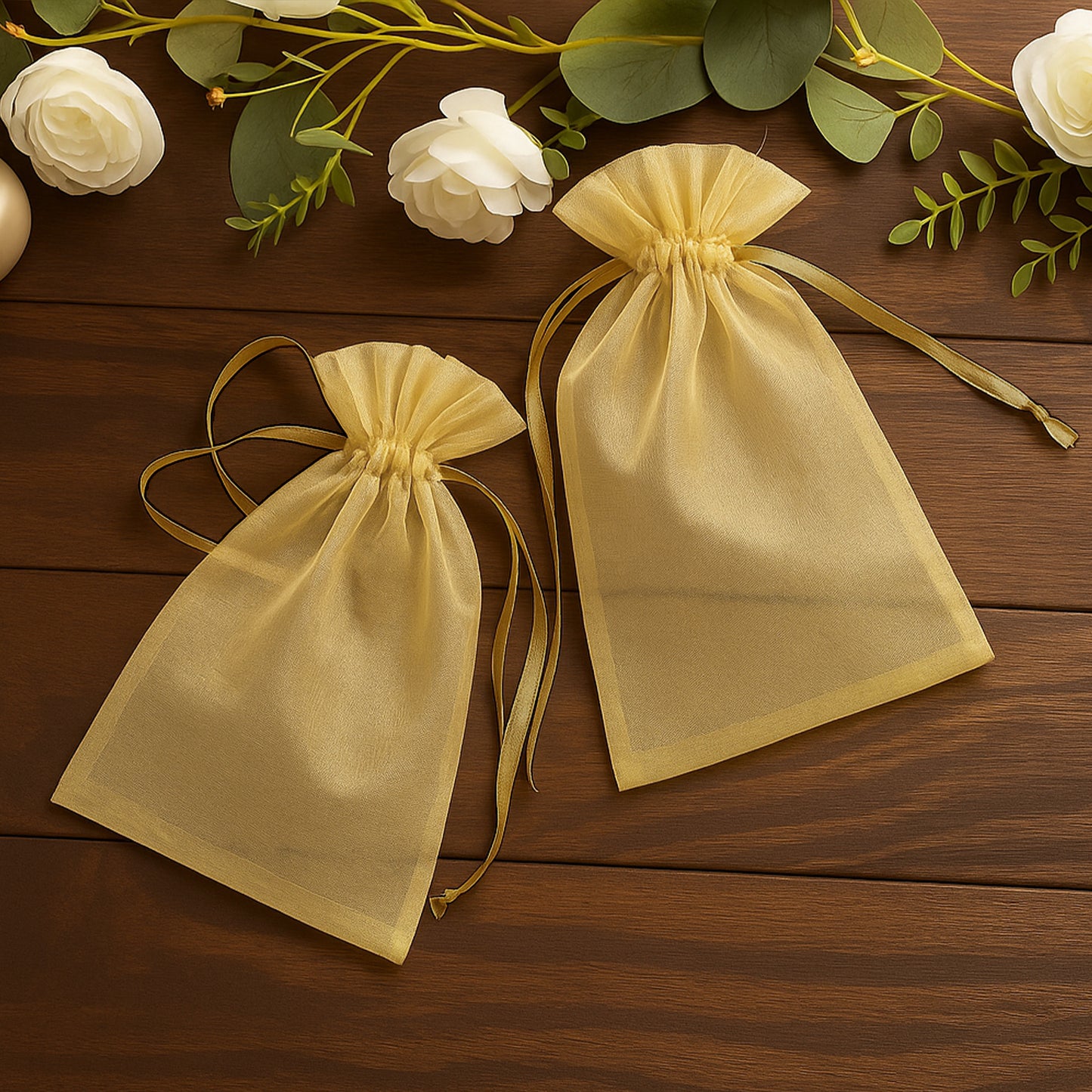 Gold organza gift bags with drawstring, perfect for wedding favors.