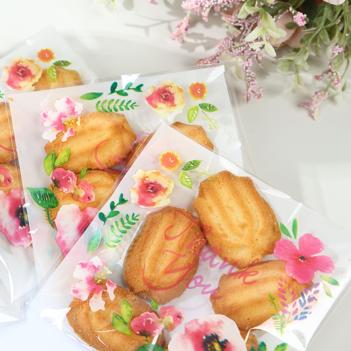 Clear white PVC favor bags with floral print and self-adhesive seal.