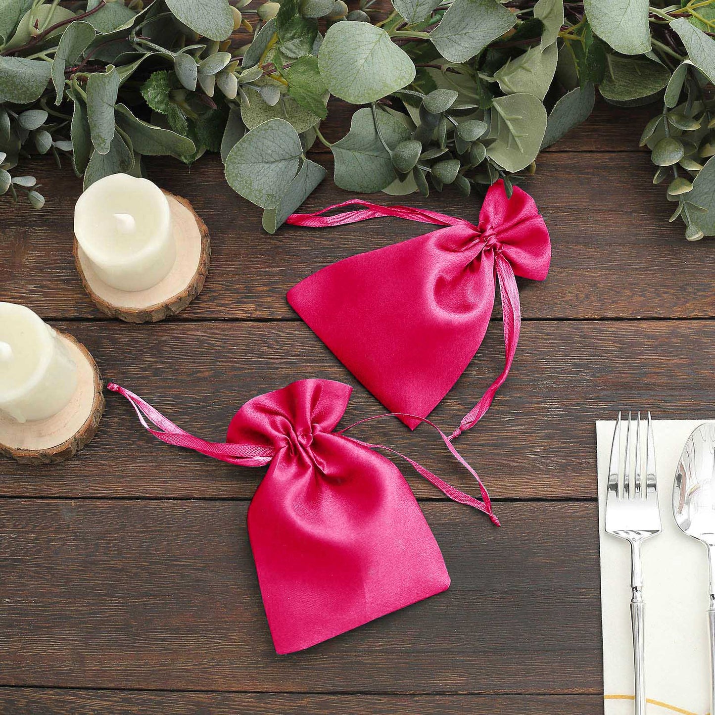 Fuchsia satin drawstring gift bags for weddings and parties.