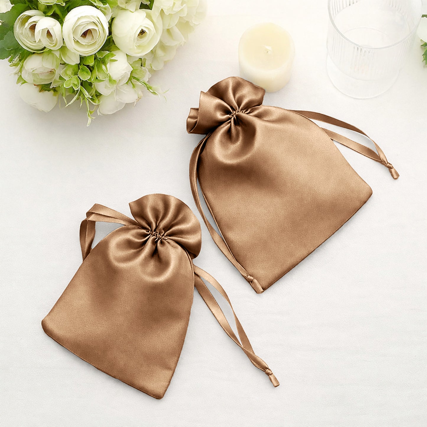 Antique gold satin drawstring gift bags for wedding favors.