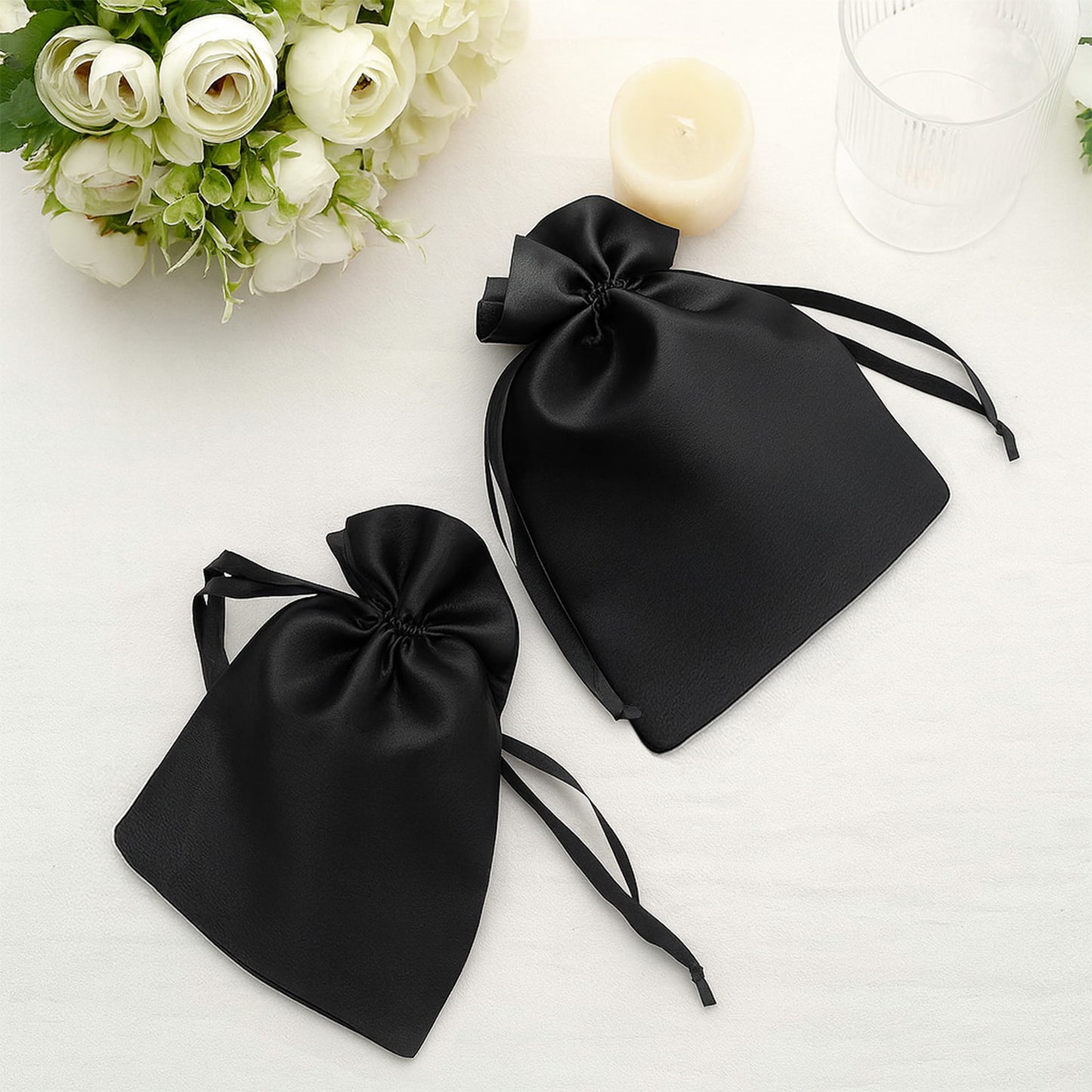 Black satin drawstring gift bags for weddings and parties.