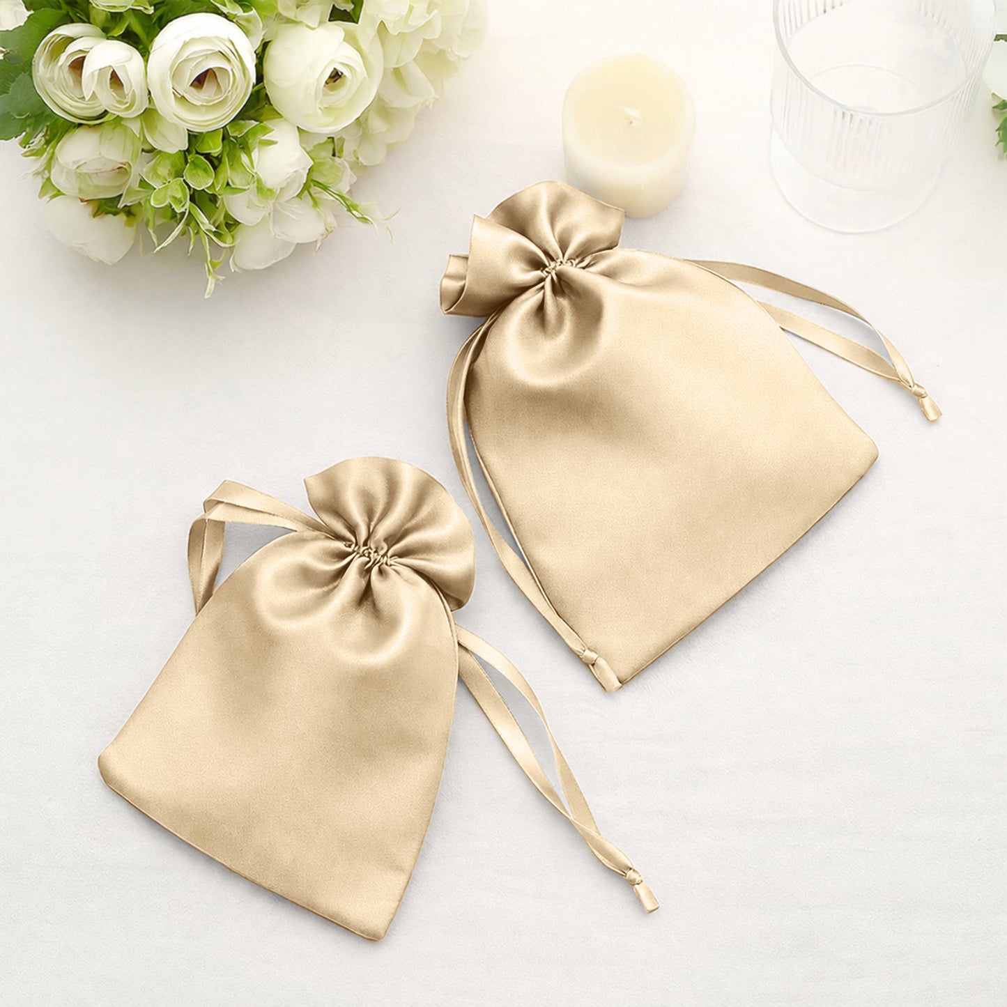 Champagne satin drawstring gift bags for wedding party favors.