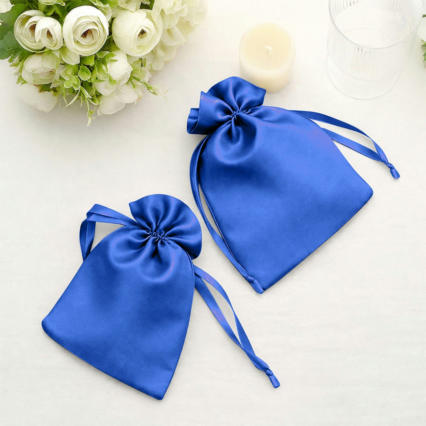 Royal blue satin drawstring bags for wedding party favors.