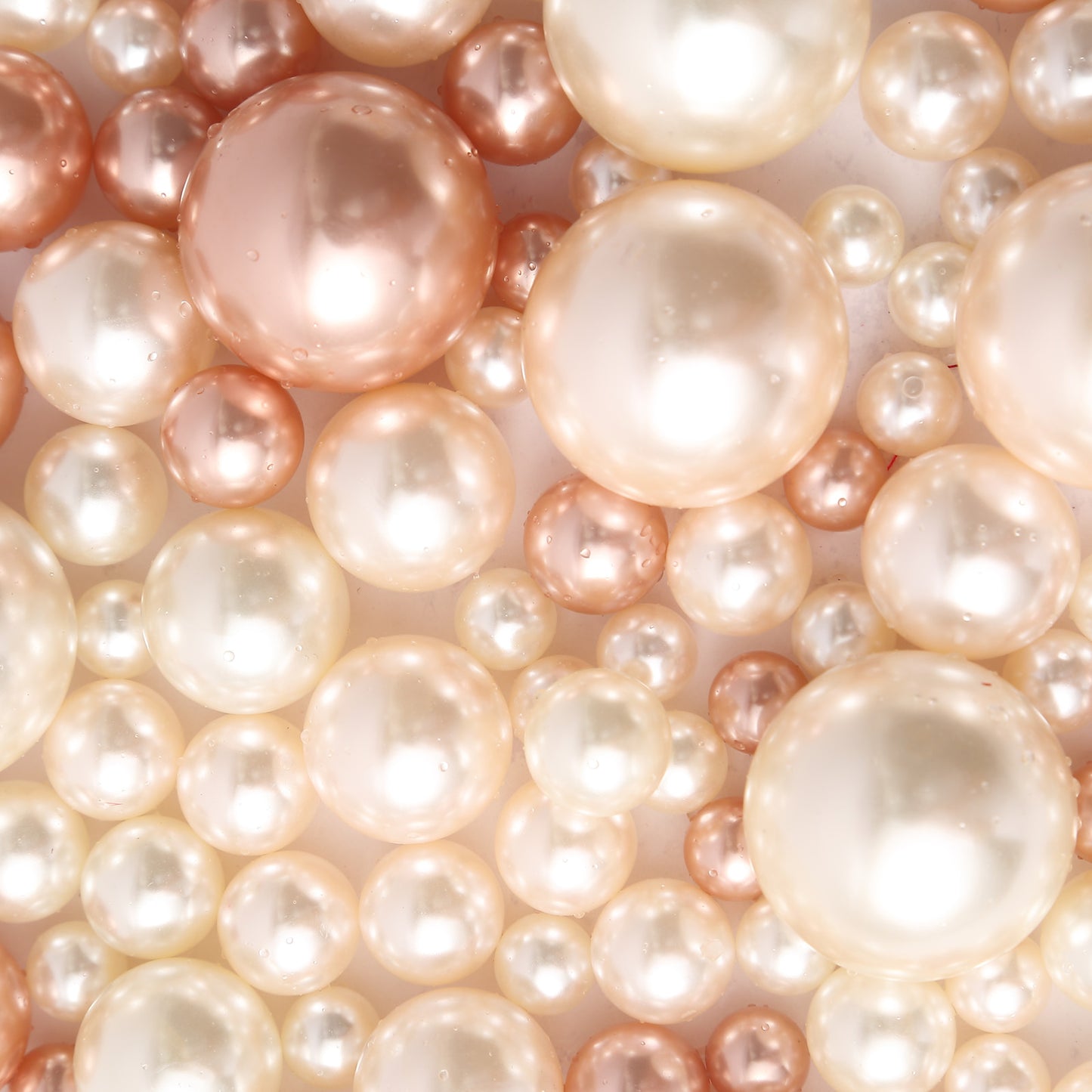 Rose gold and off white faux pearl beads for DIY crafts.