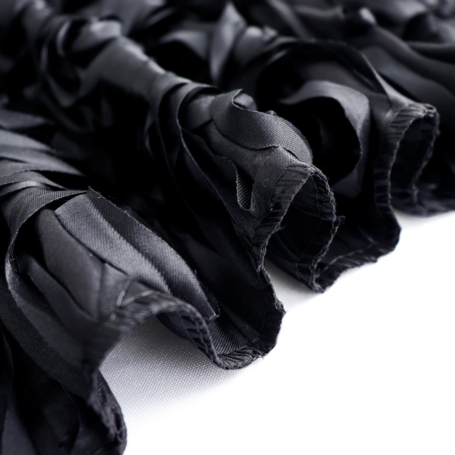 Black satin rosette event curtain drapes for elegant backdrops.