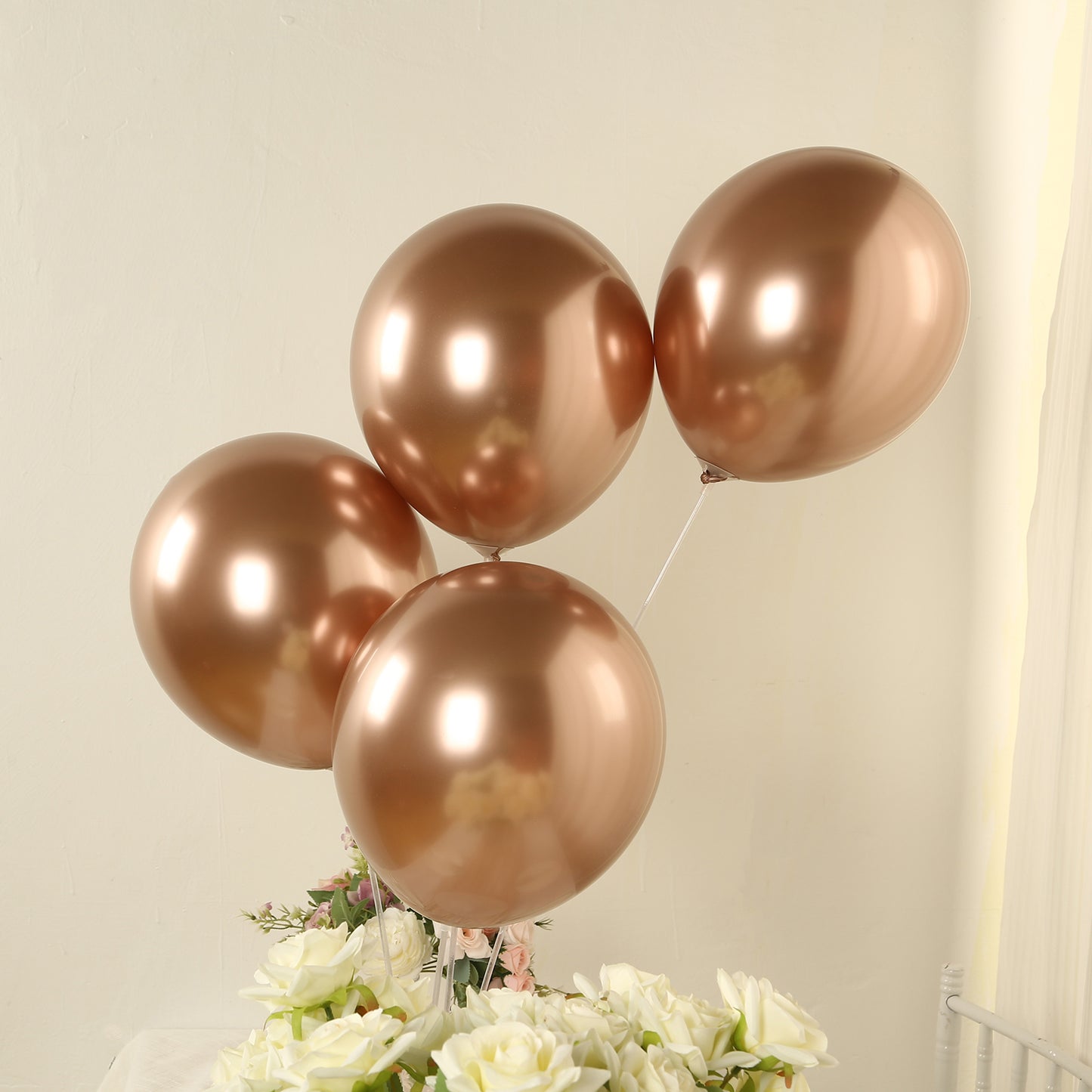 Chrome rose gold biodegradable latex balloons in a party setting.