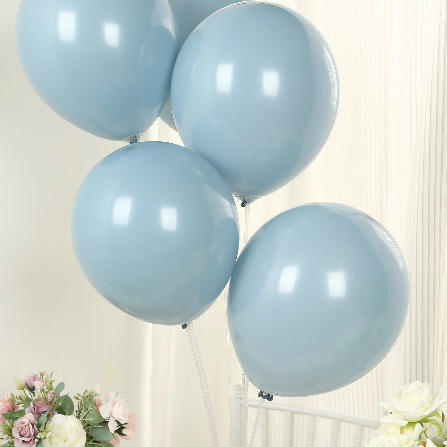 Matte pastel dusty blue biodegradable balloons in a bunch.