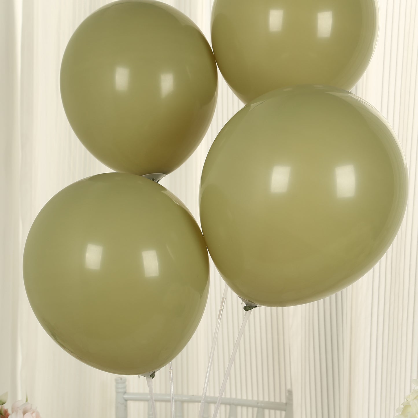 Matte pastel olive green biodegradable balloons in a cluster.