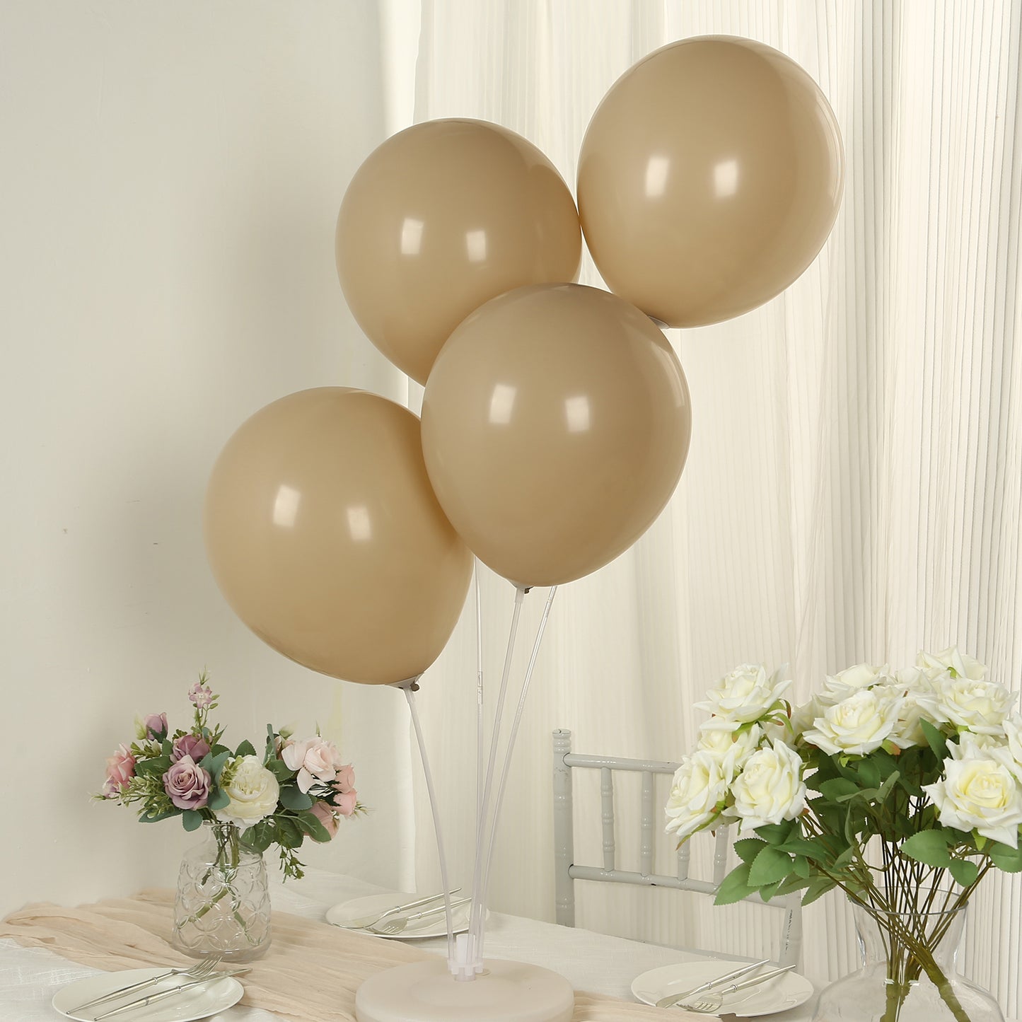 Matte pastel taupe biodegradable balloons arranged at a party table.