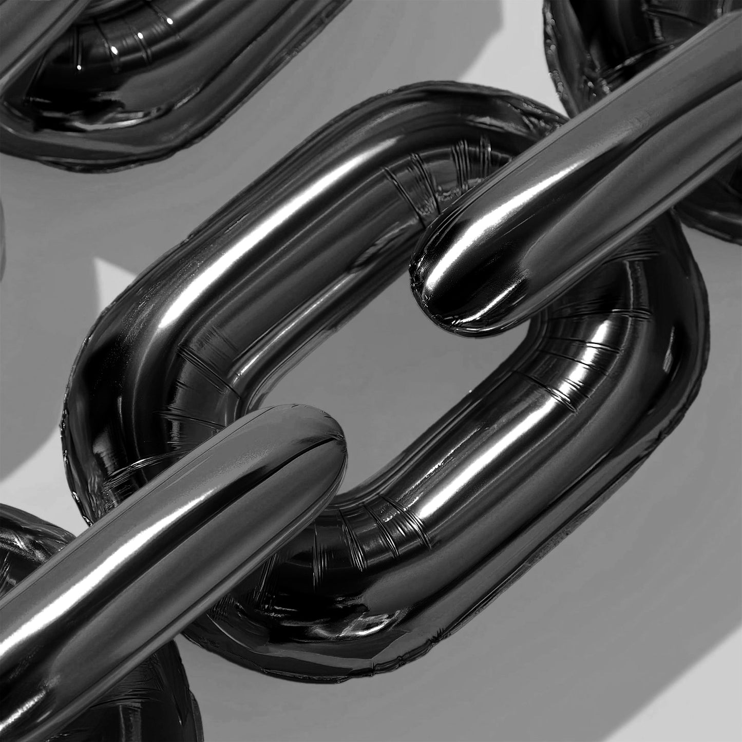 Black chain foil balloons for 90s party decor.