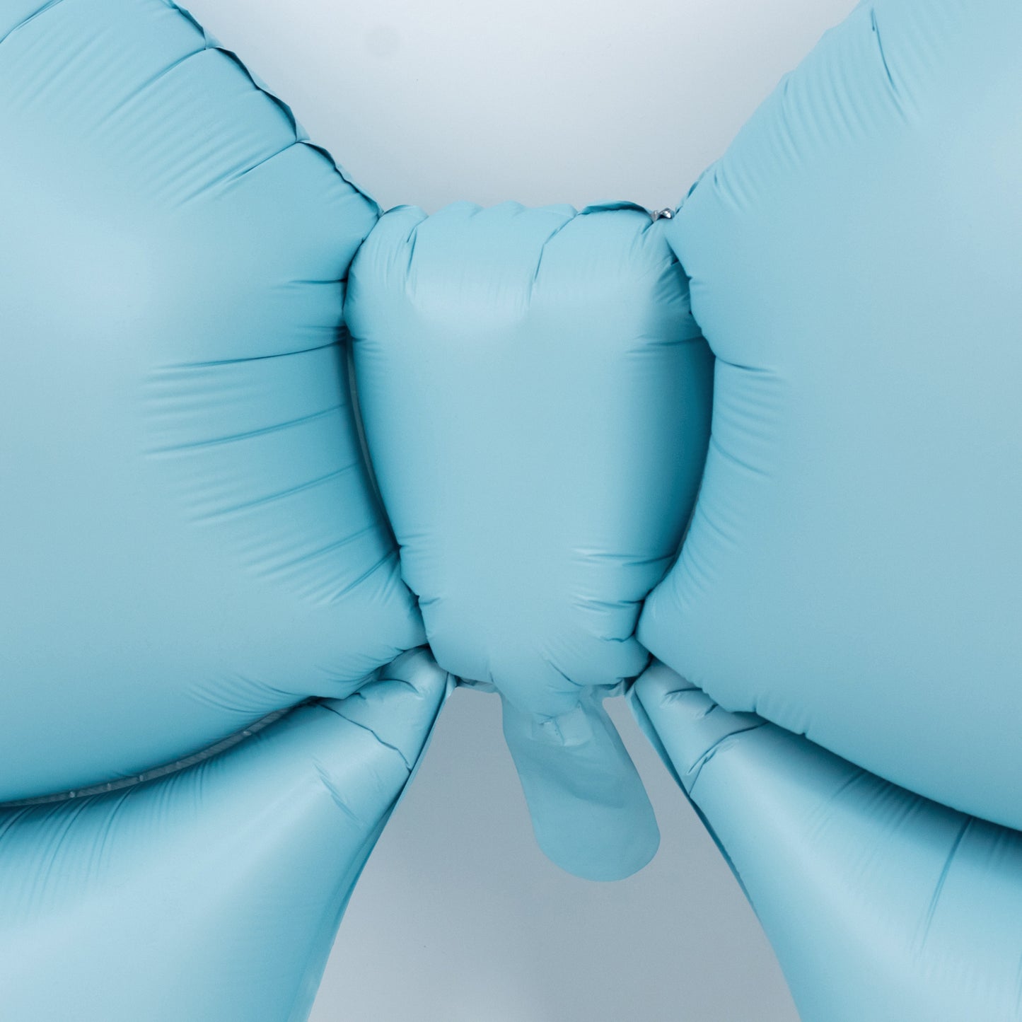 Matte light blue giant decorative foil bow balloon for party decor.