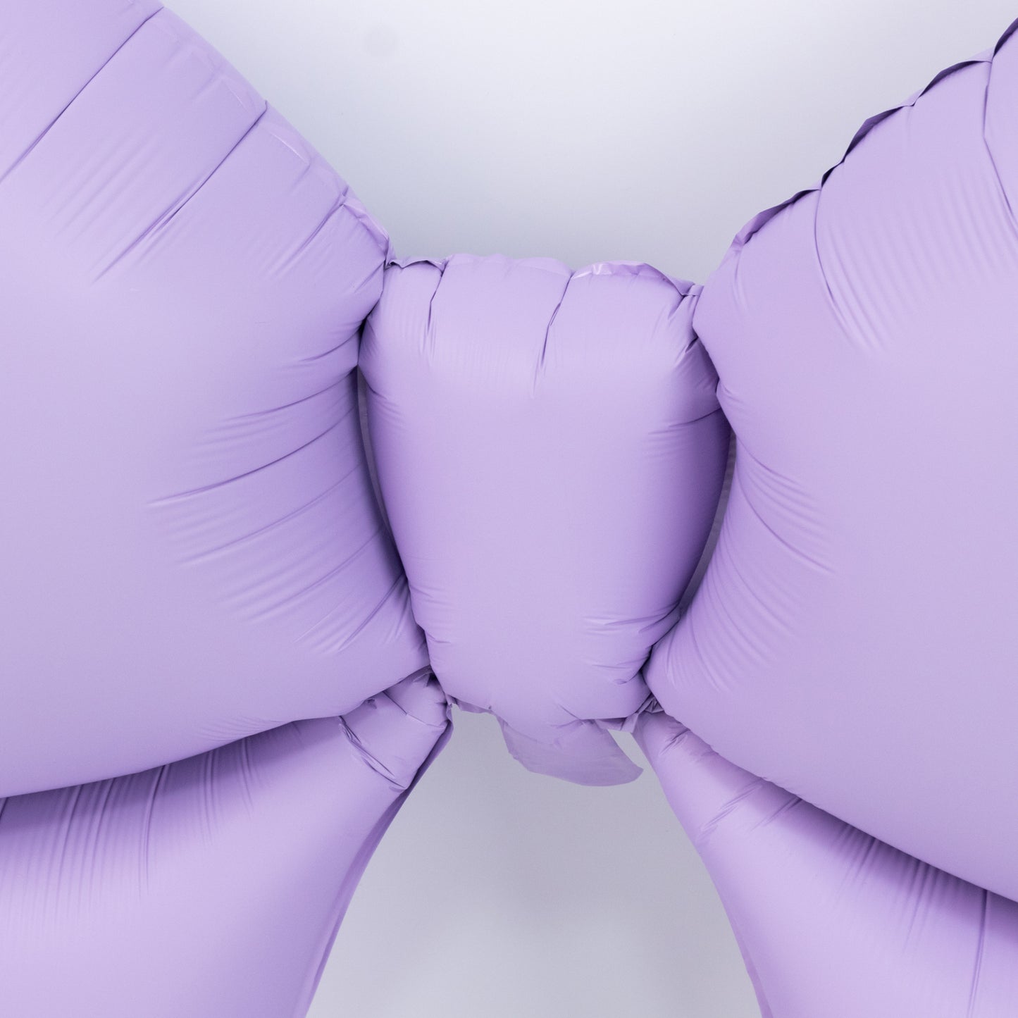 Matte lavender decorative foil bow balloon for party and event styling.