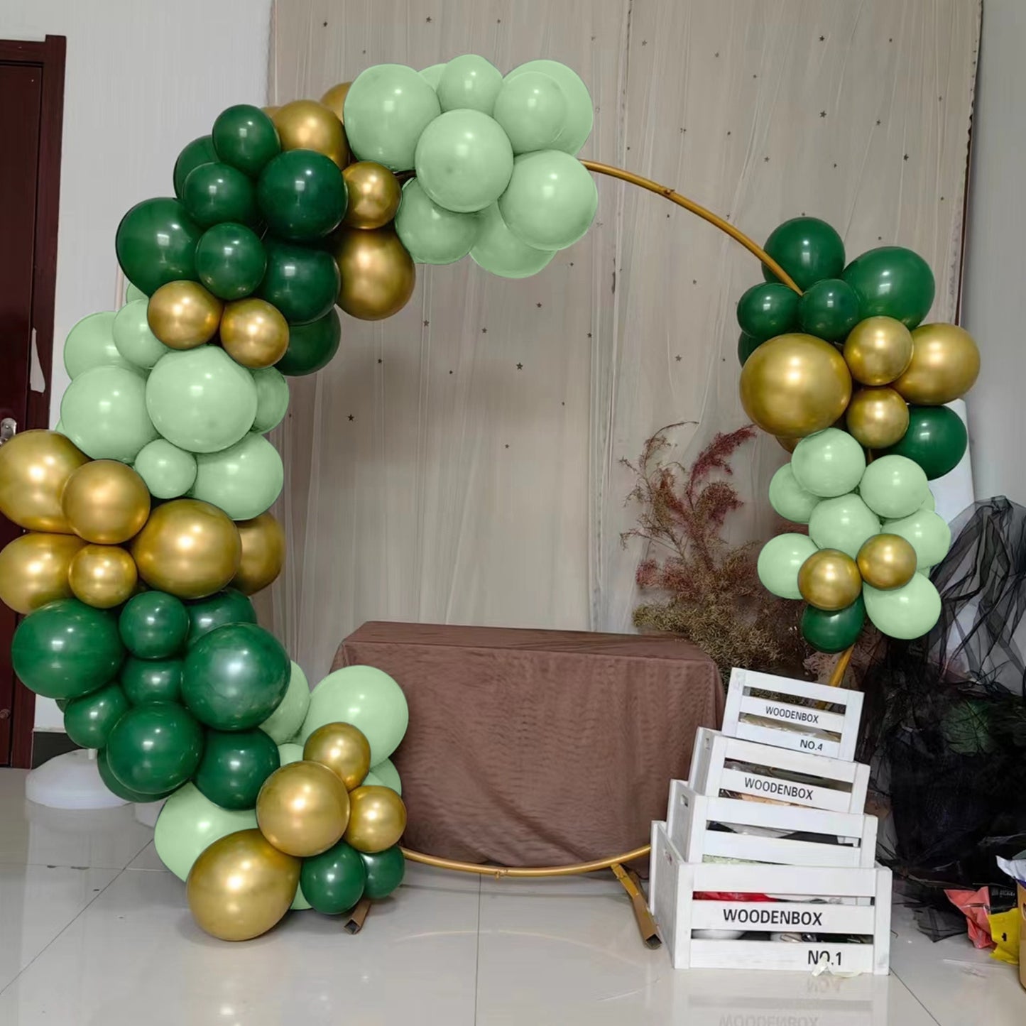 Gold and green balloon arch garland decoration.