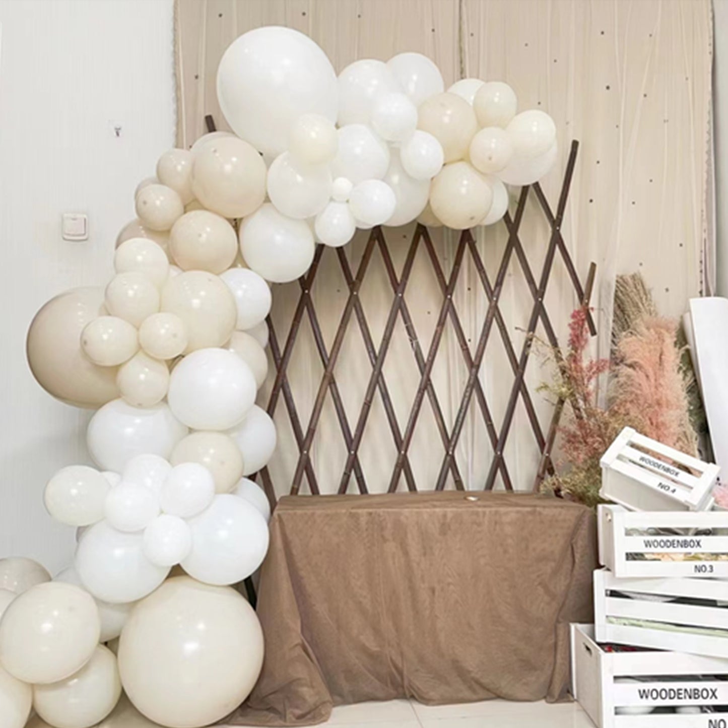 Assorted white and beige latex balloon arch garland for party decorations.