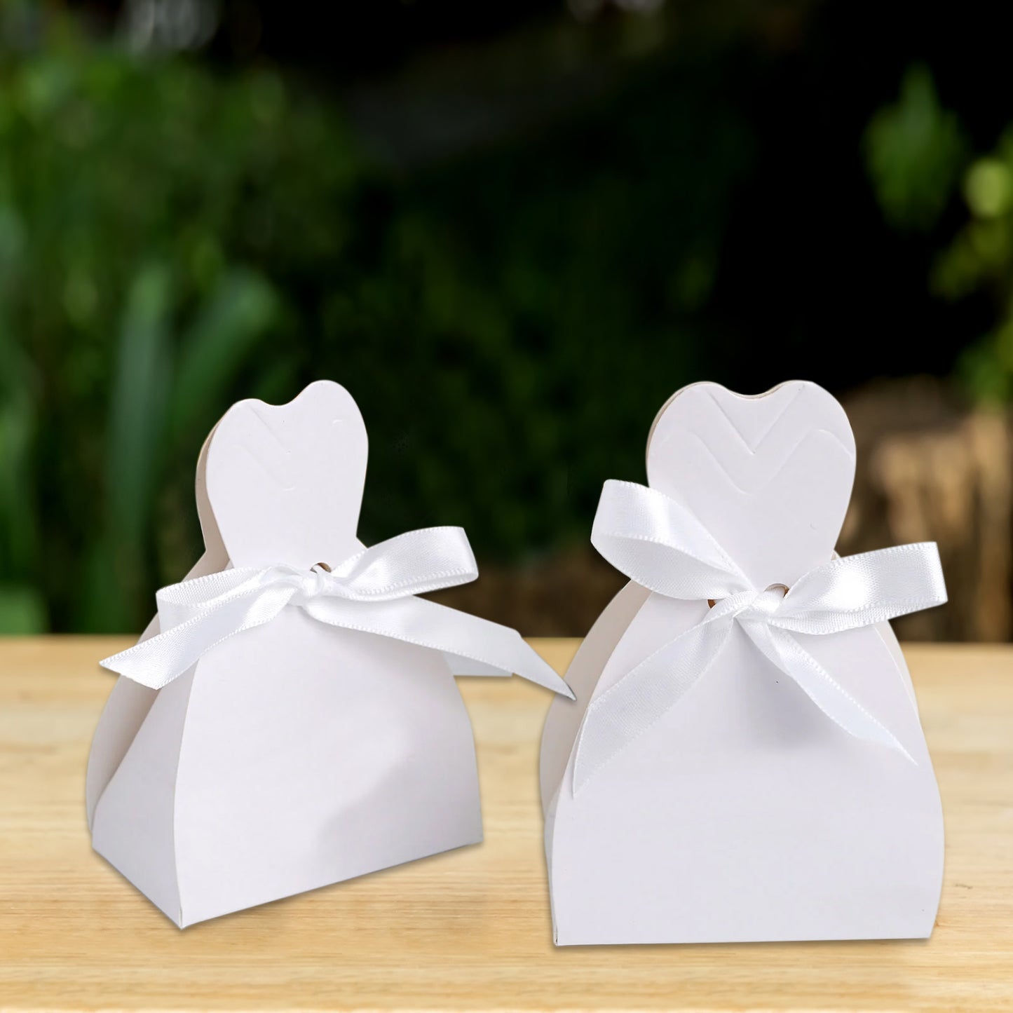 White wedding dress candy gift boxes with ribbon ties.