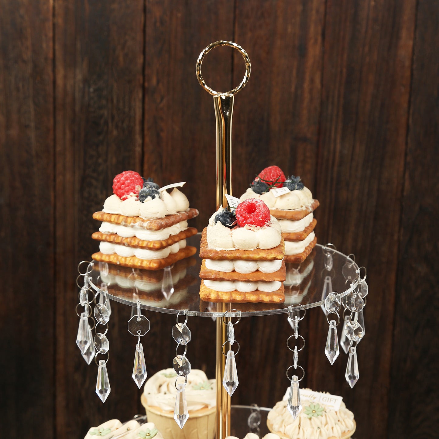Gold 3-tier acrylic and metal cupcake stand with hanging crystals.