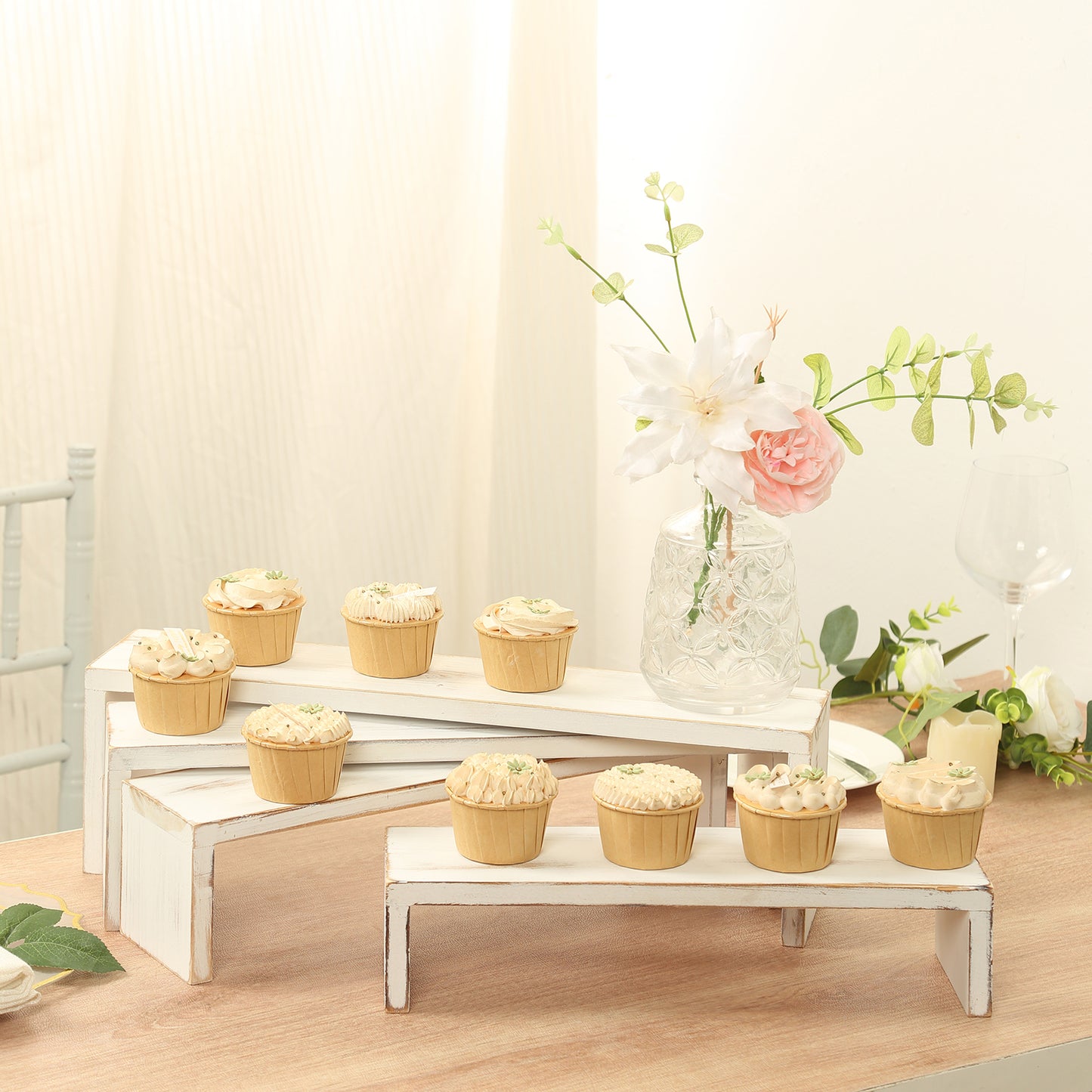 Whitewash wooden display risers with cupcakes, rustic farmhouse style.