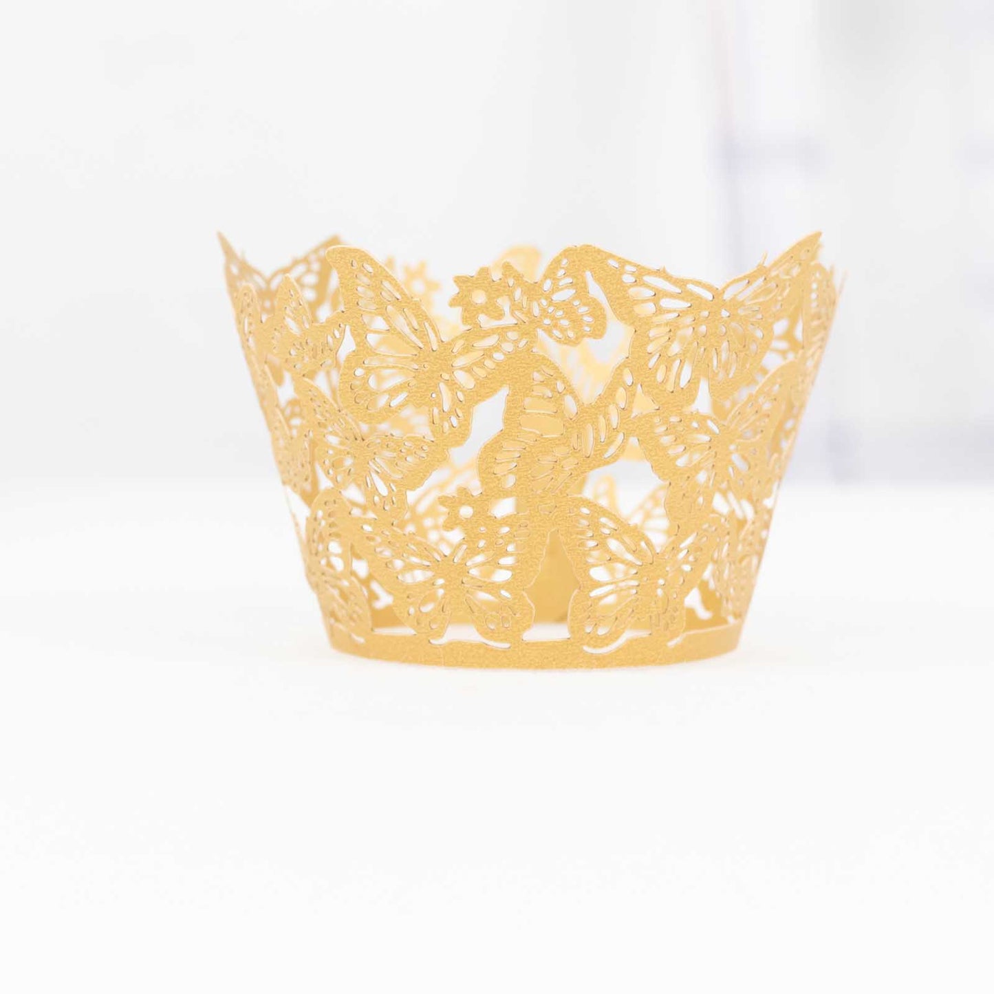 Gold butterfly lace cupcake wrapper, perfect for muffins and desserts.