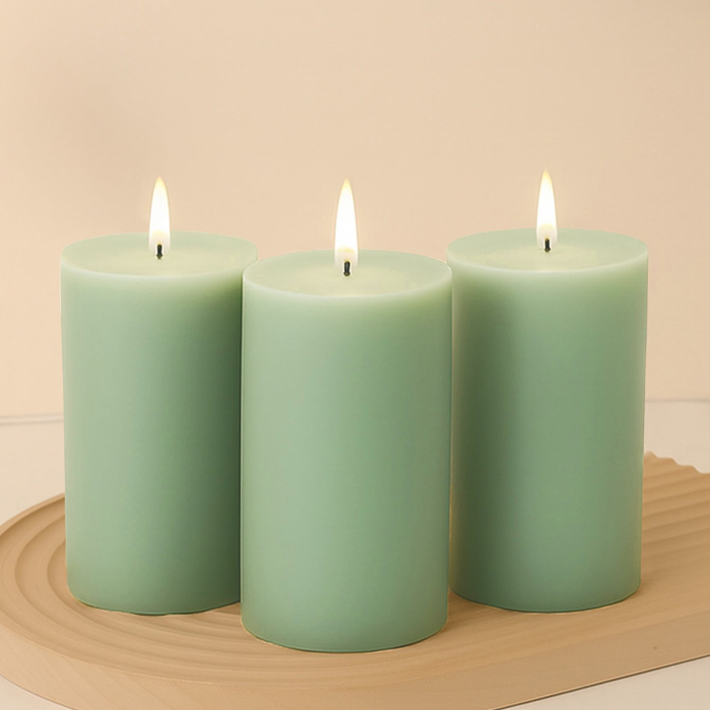 Sage green unscented dripless pillar candles with clean flames.