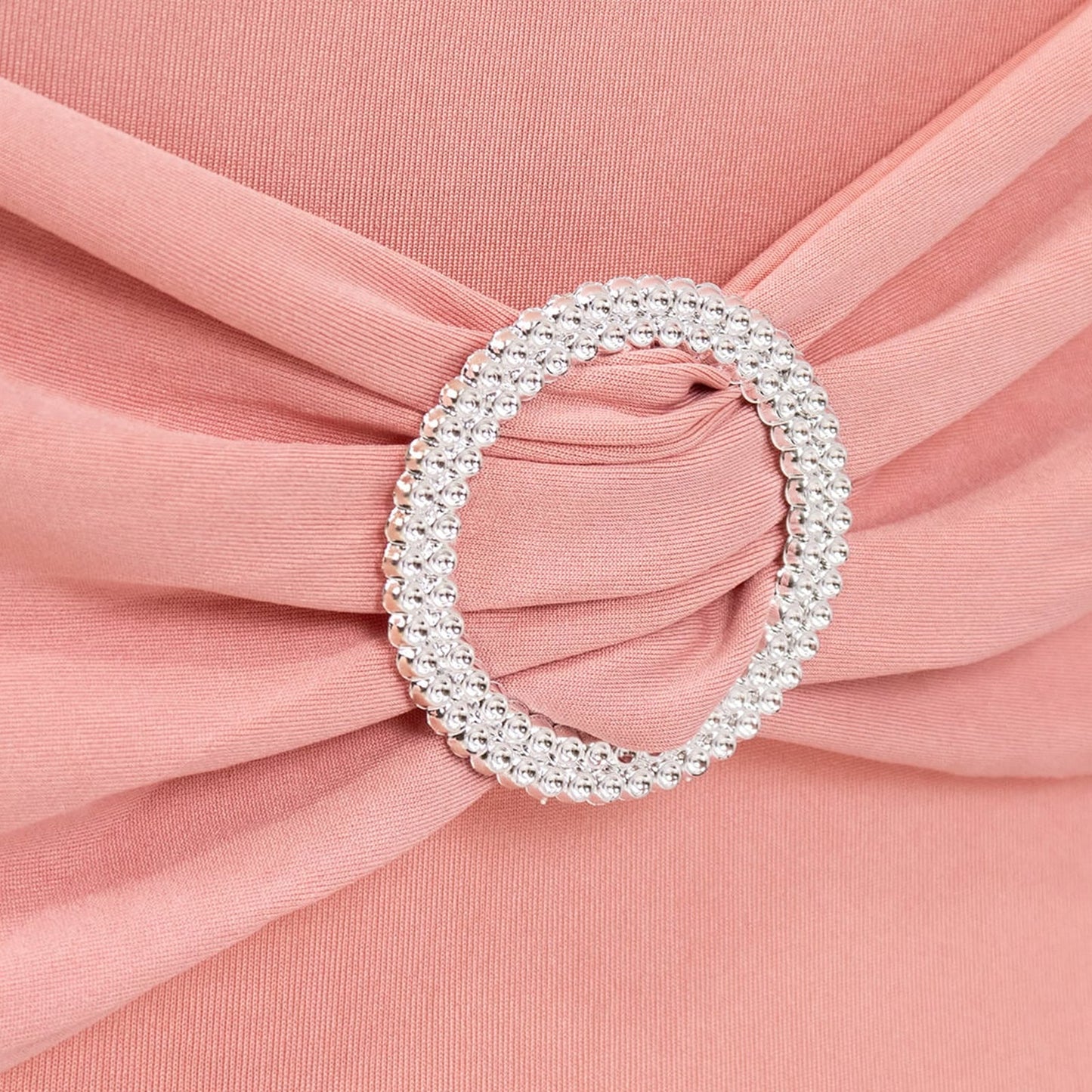 Blush spandex chair cover with silver rhinestone buckle detail. #whtbkgd