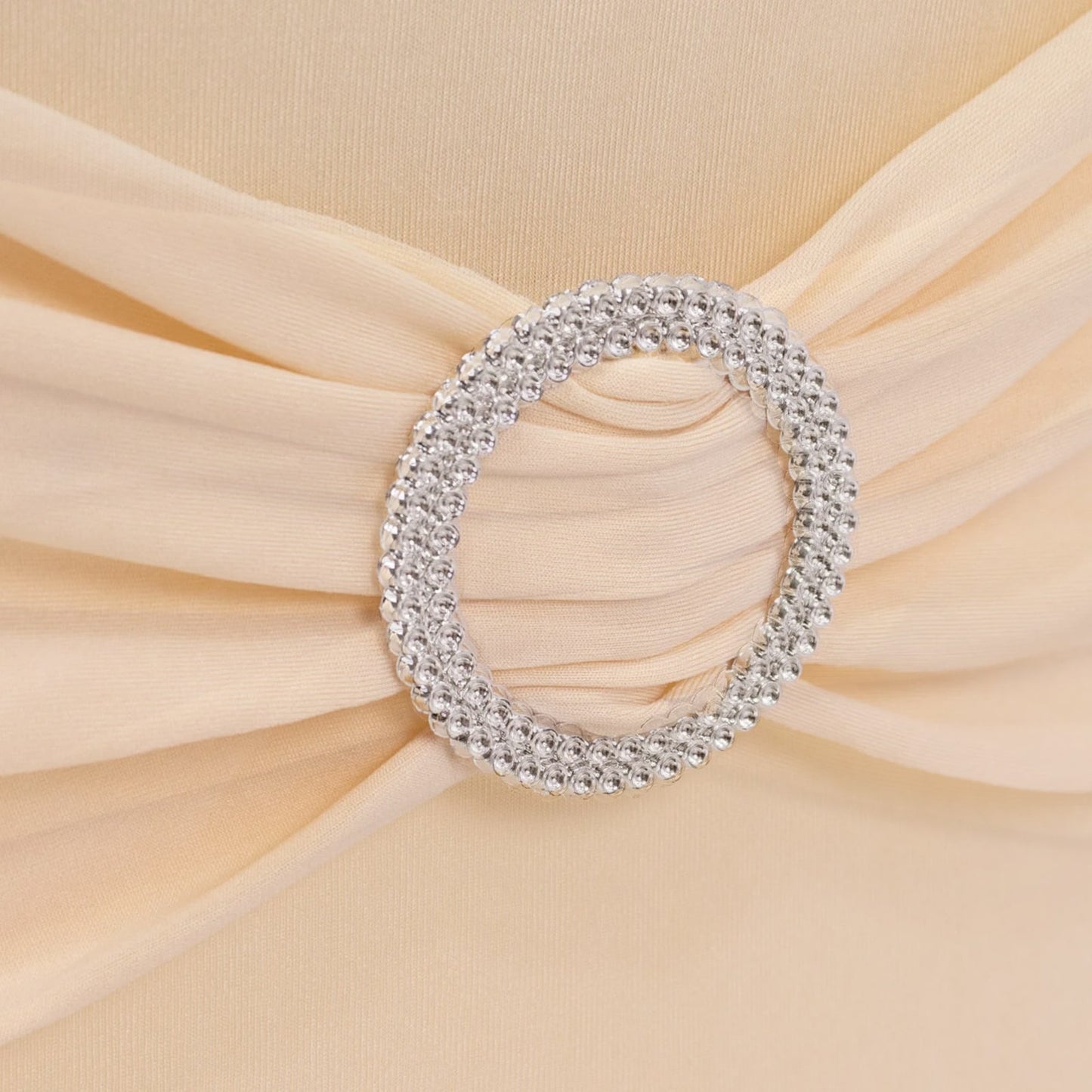 Beige folding chair cover with silver rhinestone sash. #whtbkgd