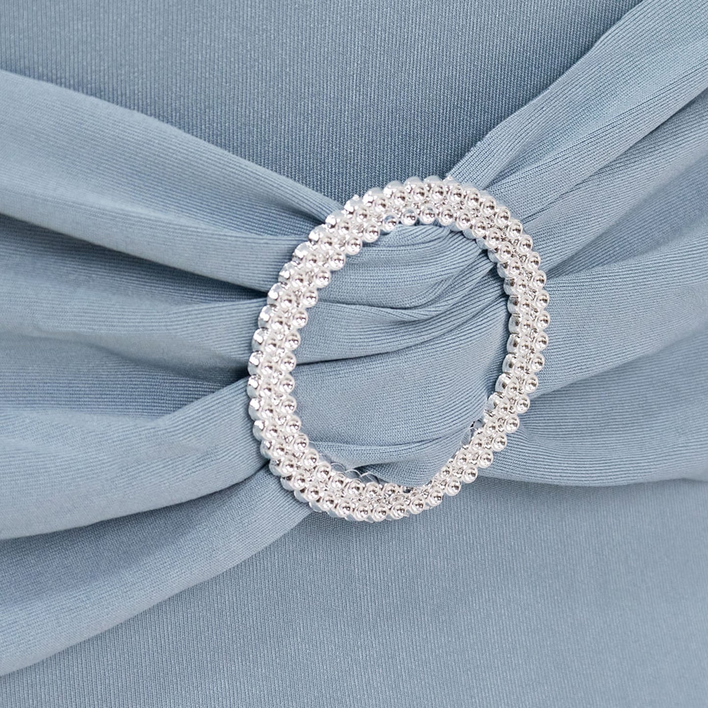 Dusty blue chair cover with silver rhinestone buckle detail. #whtbkgd