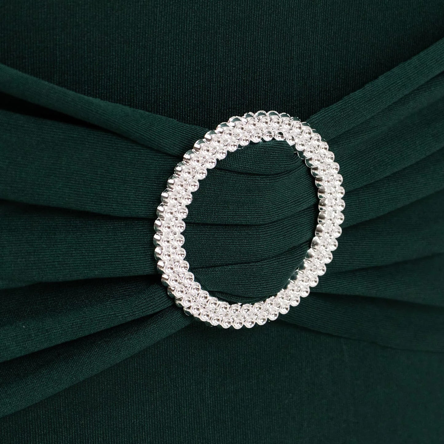 Emerald green chair cover with silver rhinestone buckle detail. #whtbkgd