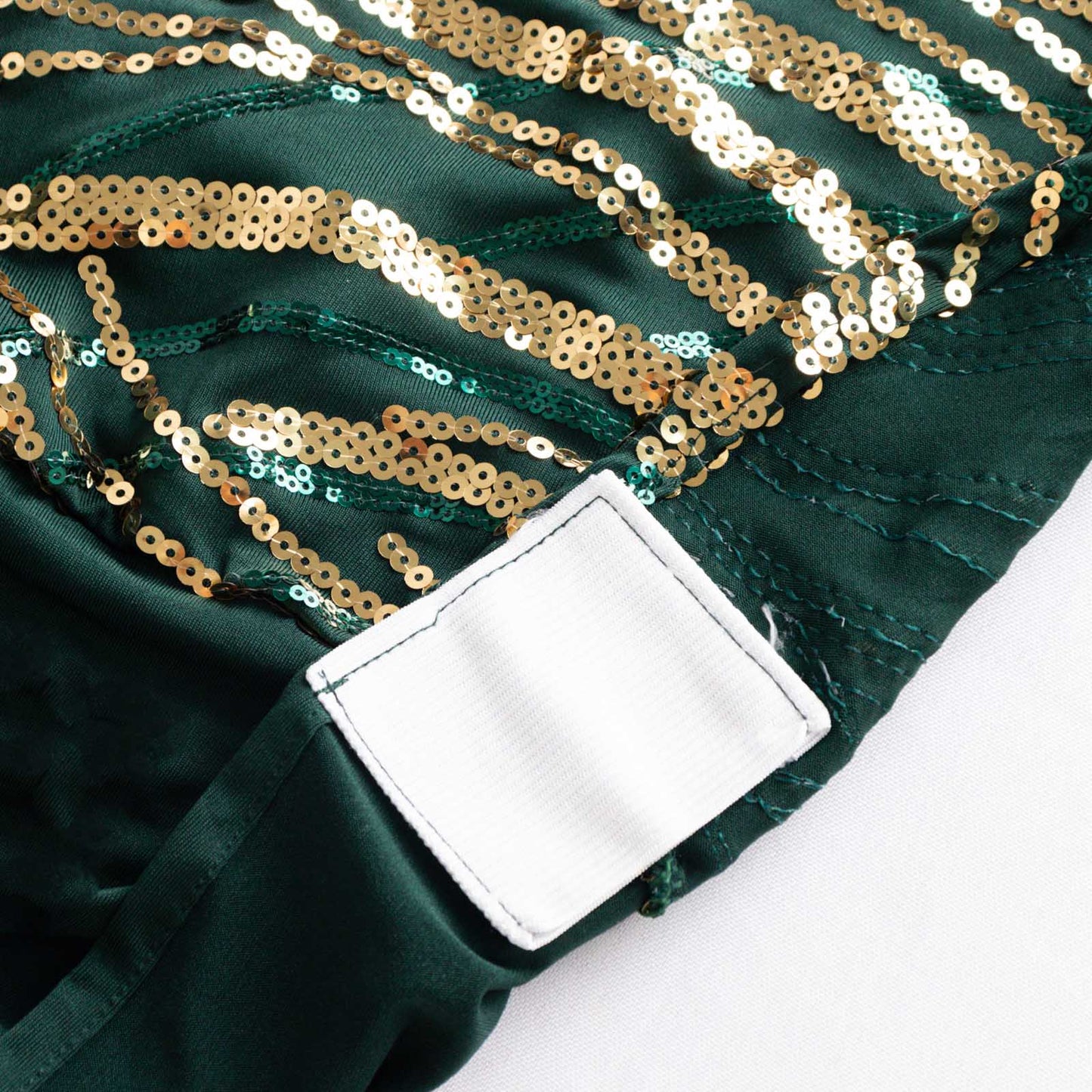 Emerald green fitted banquet chair cover with gold sequins.