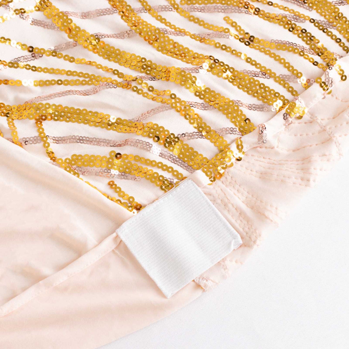 Rose gold spandex banquet chair cover with gold wave sequins.