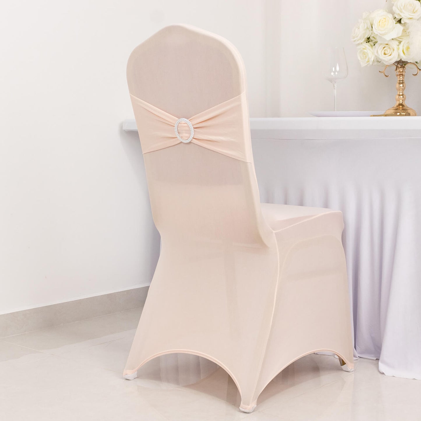 Blush spandex banquet chair cover with silver rhinestone sash.
