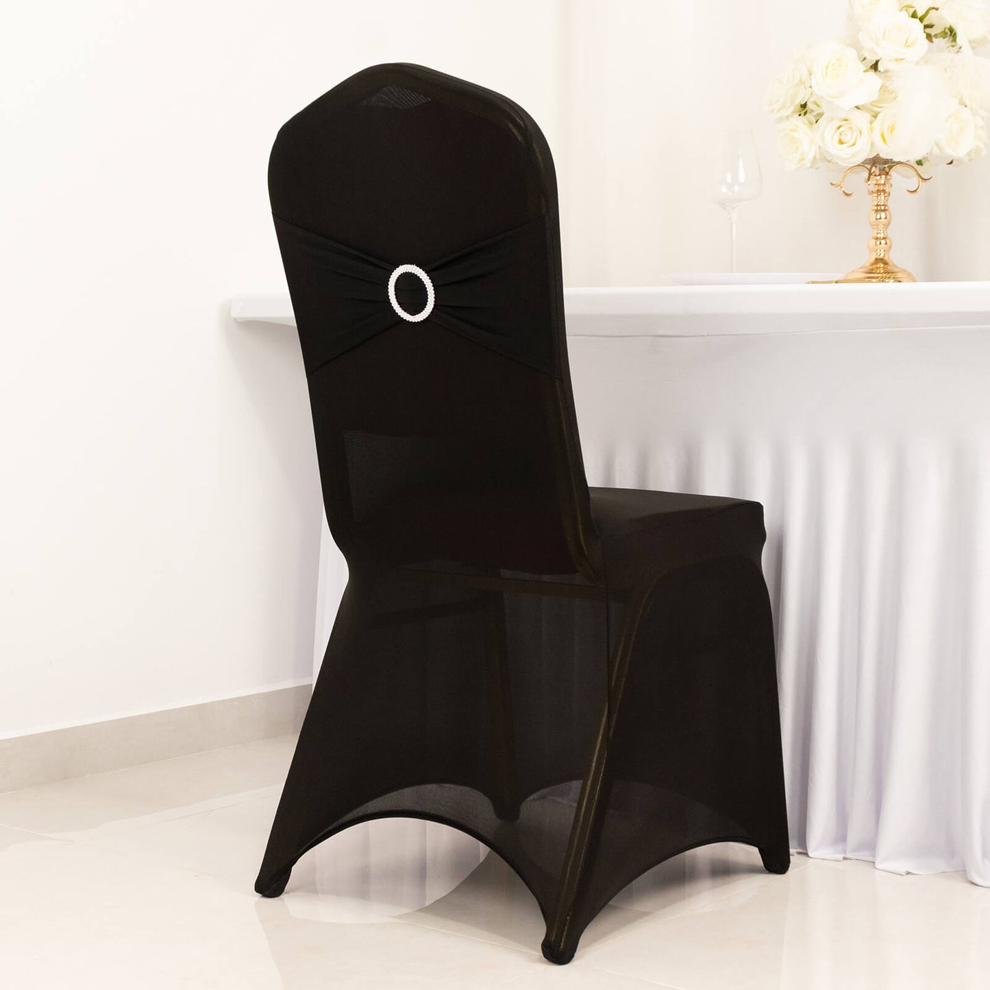 Black spandex banquet chair cover with silver rhinestone sash.