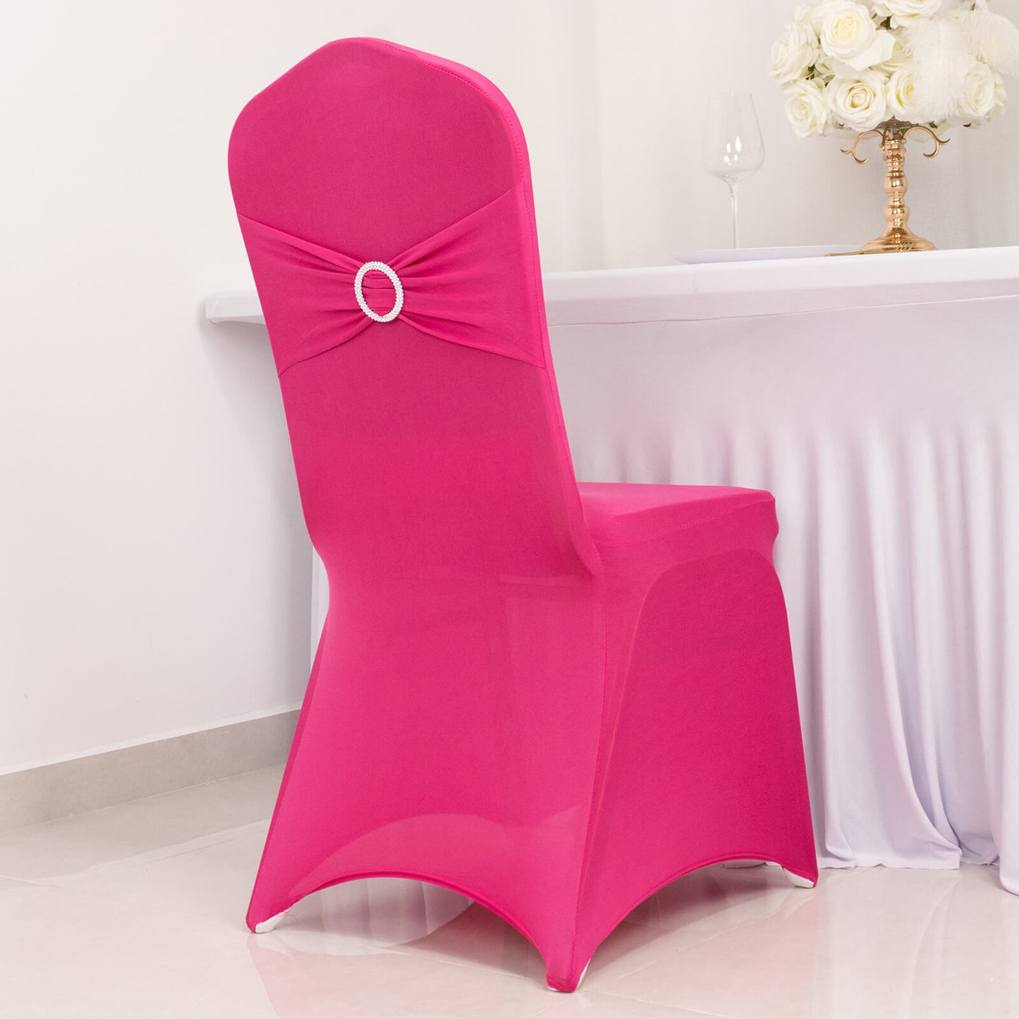 Fuchsia spandex banquet chair cover with silver rhinestone sash.
