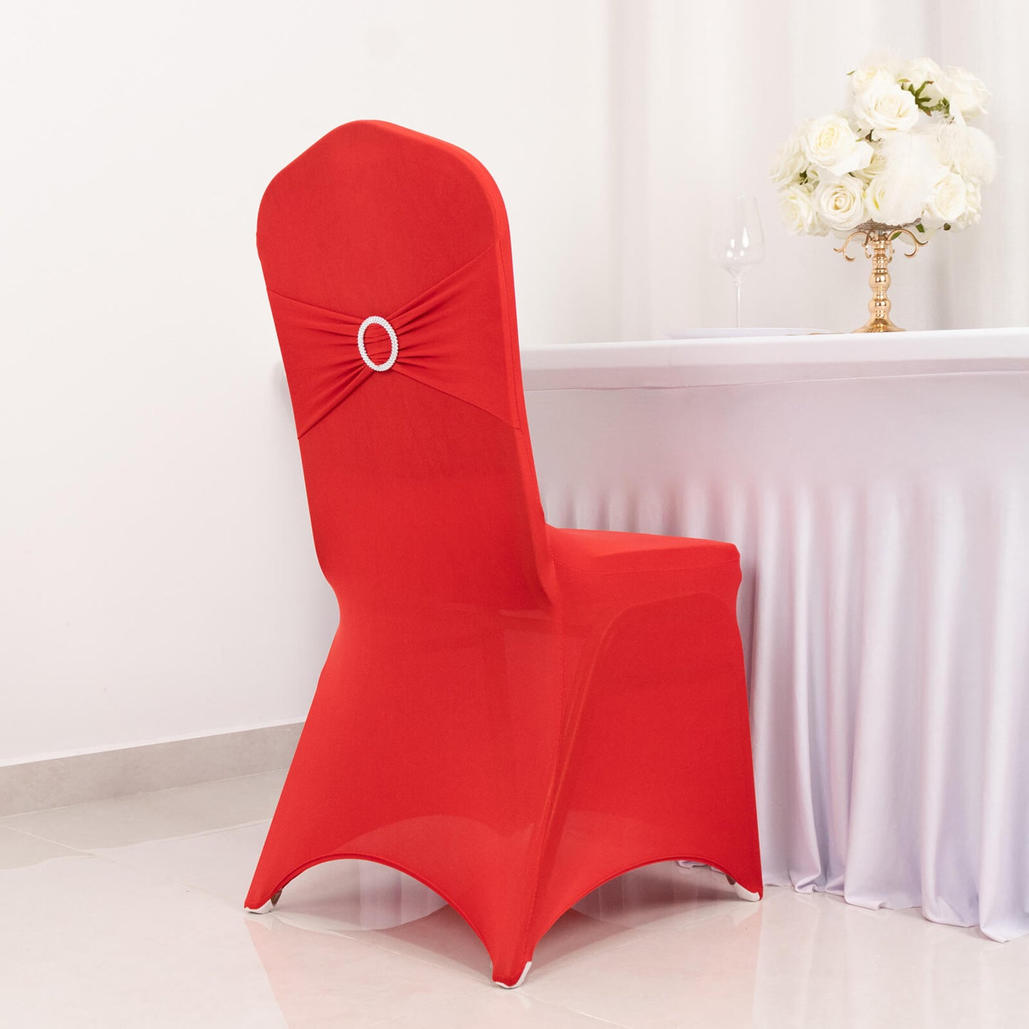 Red spandex banquet chair cover with silver rhinestone sash.