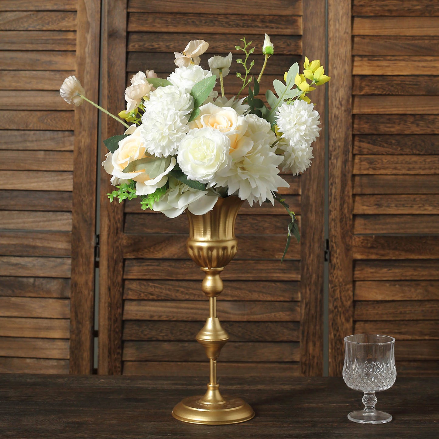 Metallic gold vintage trumpet vase with floral arrangement centerpiece.
