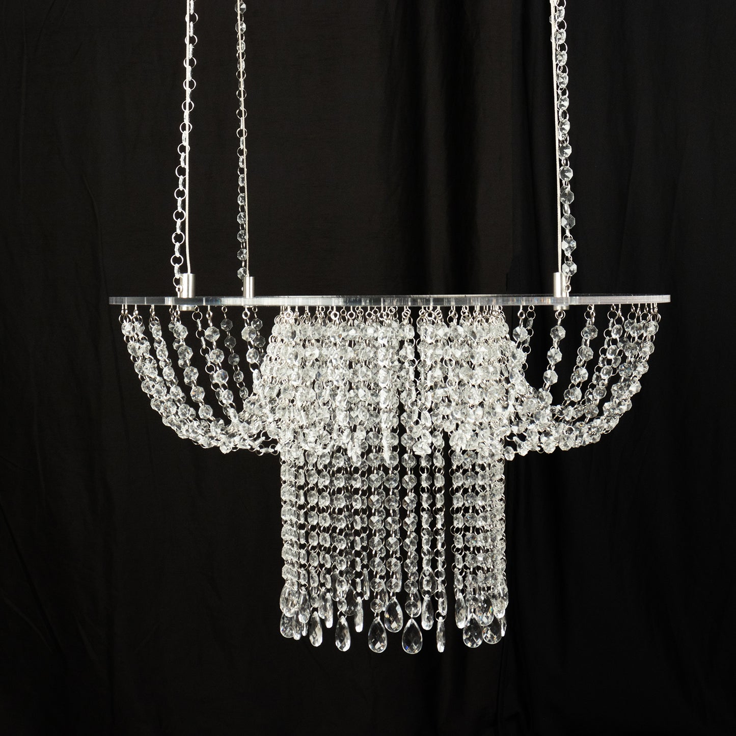 Clear acrylic crystal chandelier cake stand with bead chains. Perfect for weddings.