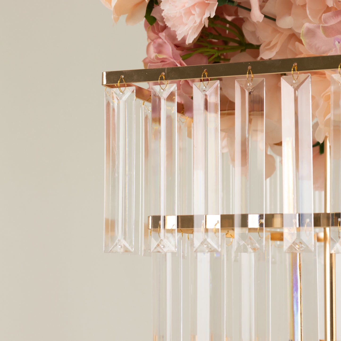 Gold crystal chandelier centerpiece with hanging crystals and floral accents.
