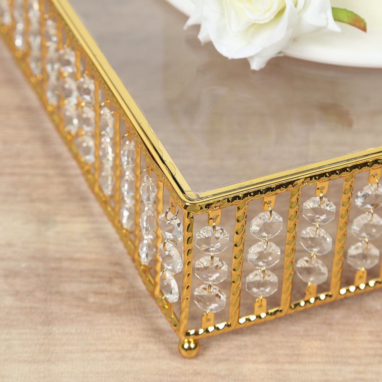 Gold cake stand with hanging crystal beads and glass top.