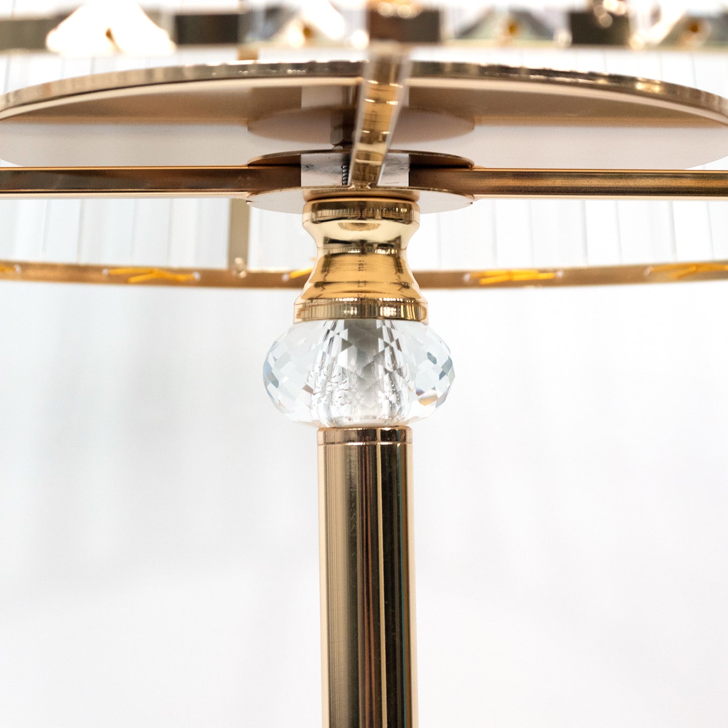Gold crystal pendant candle holder with an elegant empire lamp shade design.