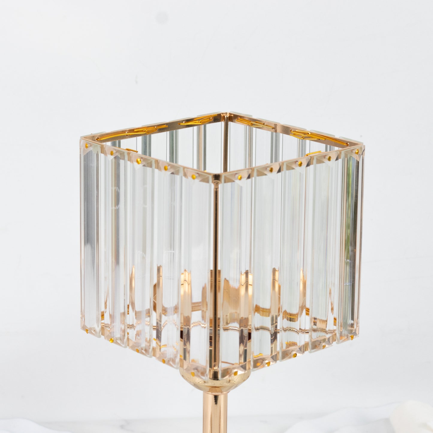 Gold crystal hurricane candle holder with a square glass design.