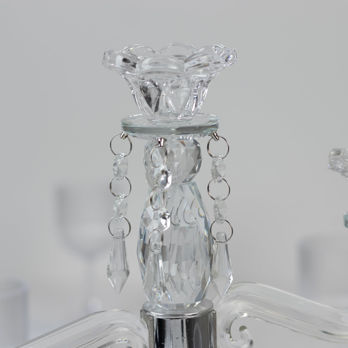 Crystal taper candle holder with hanging pendants, elegant clear design.
