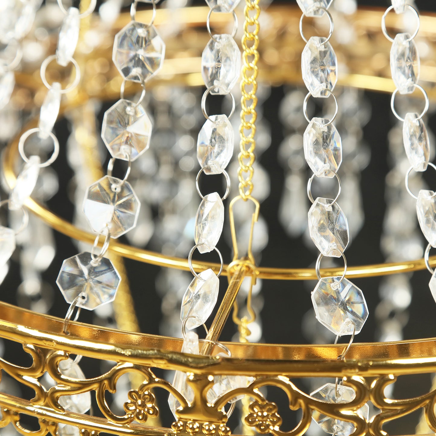 Gold beaded crystal chandelier with ornate metal frame.