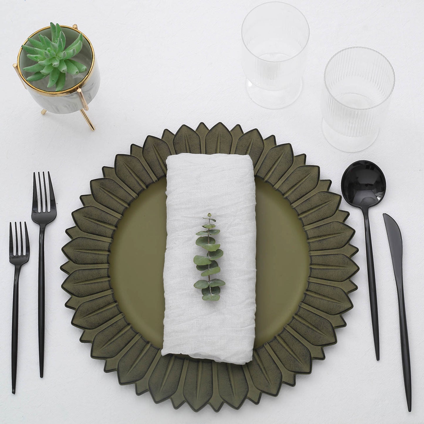 Matte olive green sunflower disposable charger plates on a table setting.