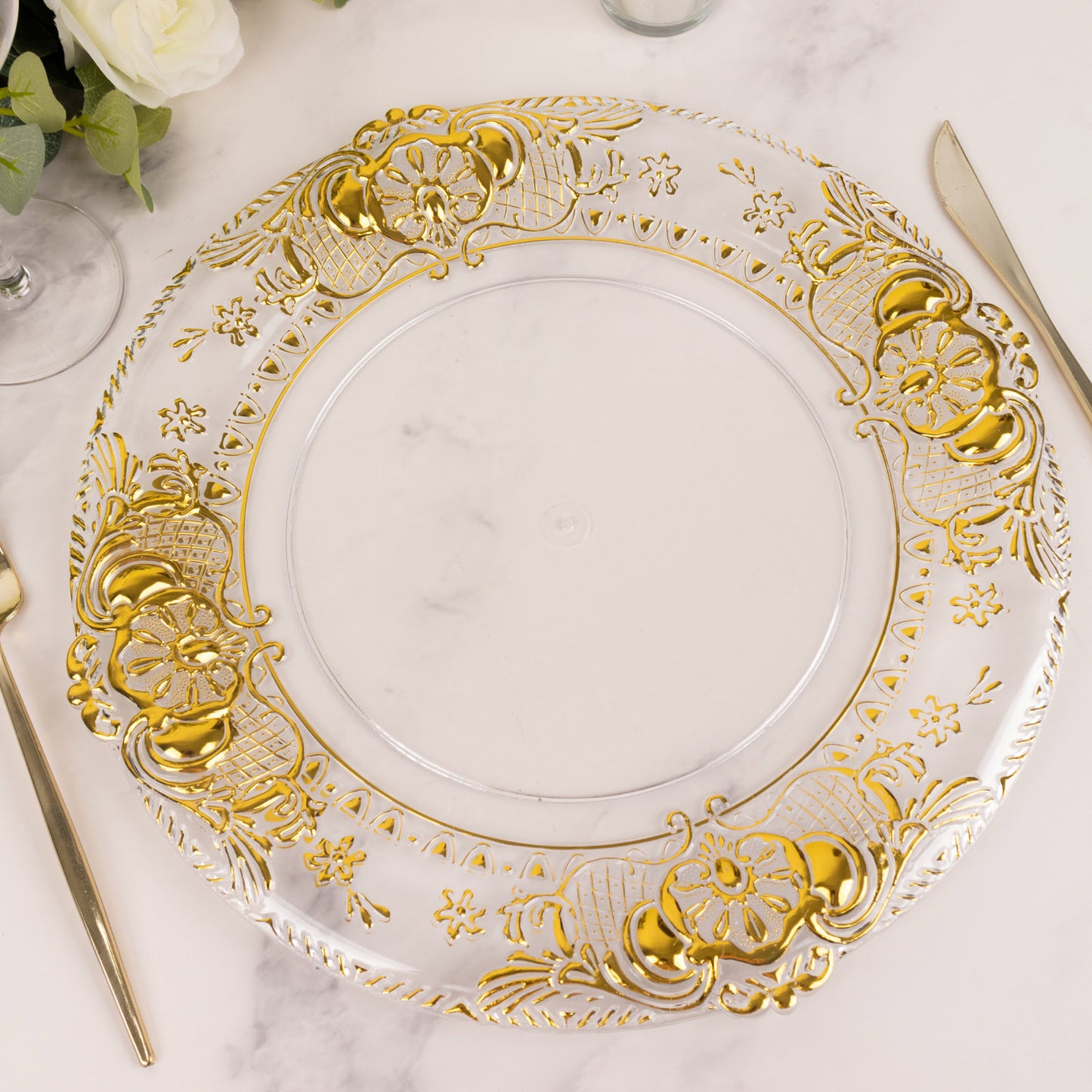 Clear decorative charger plate with gold embossed rim, 13" round.